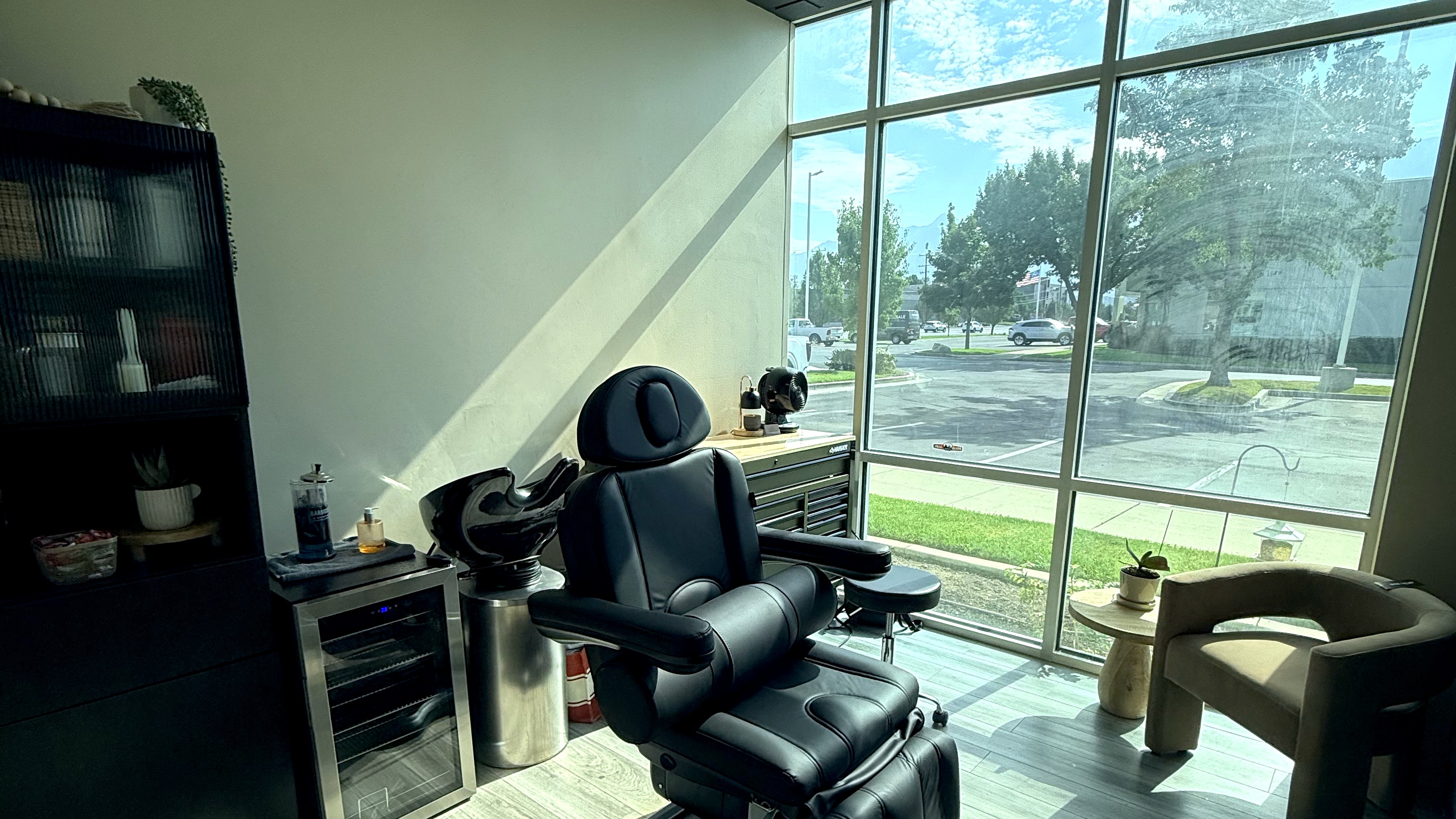 Treatment room at Wasatch Aesthetics, with the chair beside a full-height window